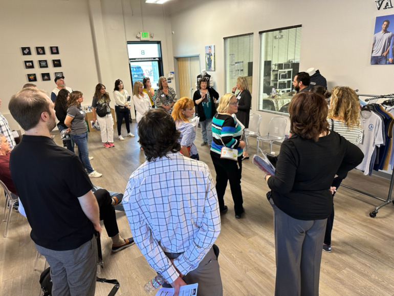 A group of people standing around the new Vantage facility.