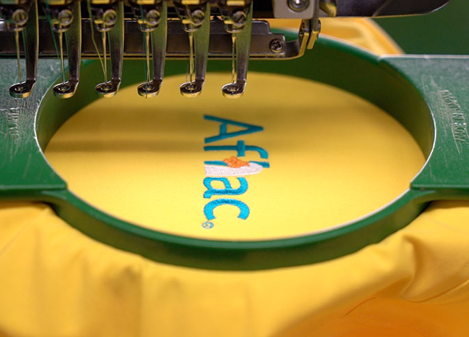 An embroidery machine decorating a shirt.