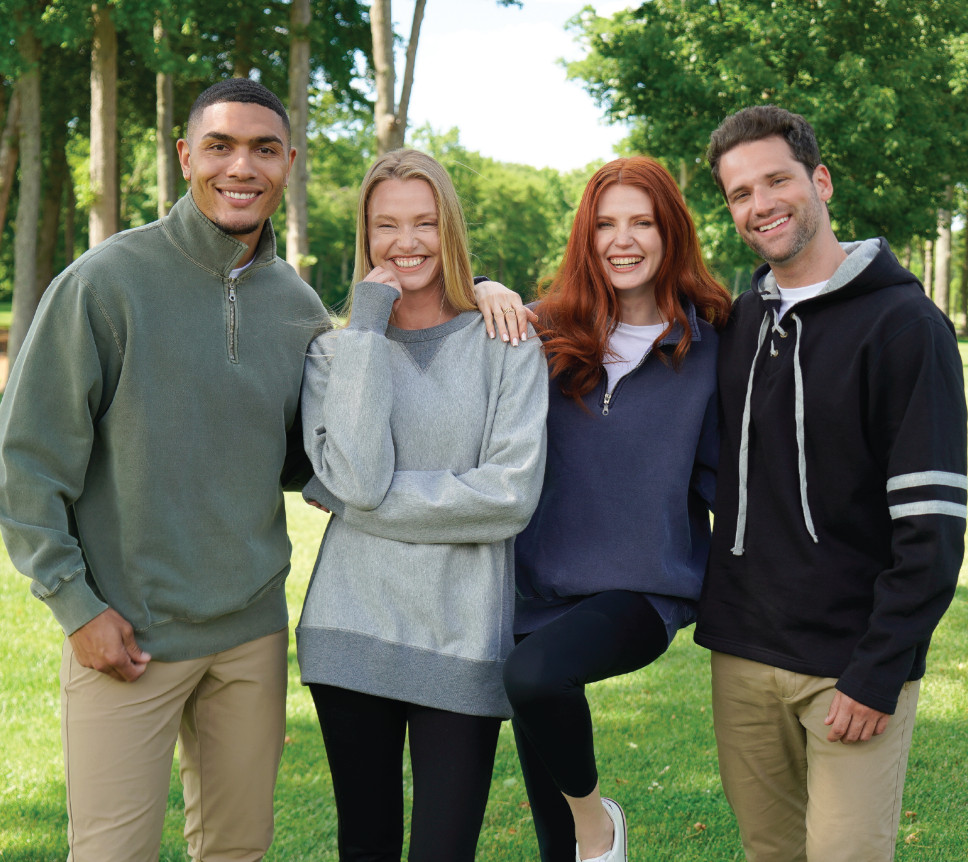 A group of models wearing a variety of earth-tone sweaters.