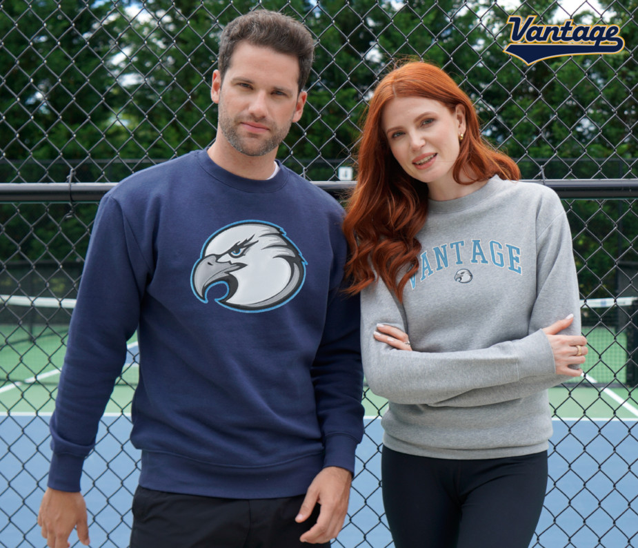 A woman and a man wearing grey and black Redwood sweaters.